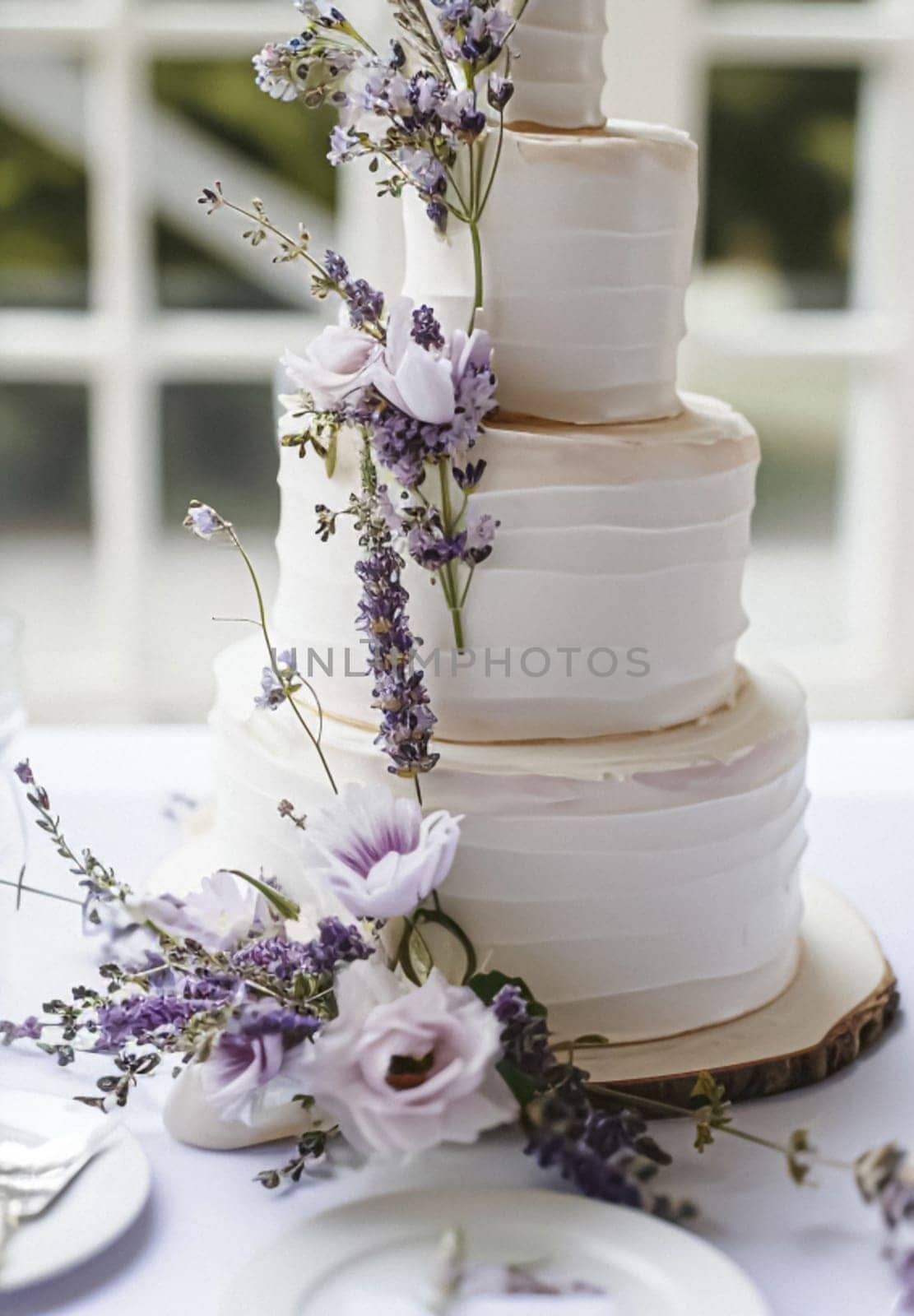 Wedding table decoration with lavender flowers, sweets and cake by Olayola