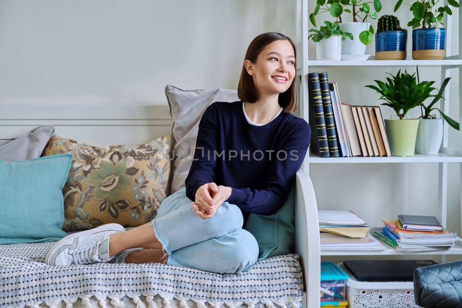 Portrait of young smiling woman in home interior by VH-studio