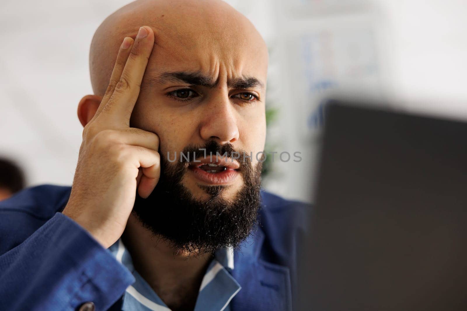 Unicorn business exhausted executive manager working on project, managing team from laptop. Arab entrepreneur analyzing financial data and creating strategy for company growth