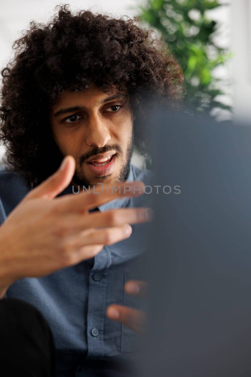 Marketing professional explaining project strategy plan to customer in online meeting. Arab entrepreneur attending corporate videoconference on laptop, talking with coworkers