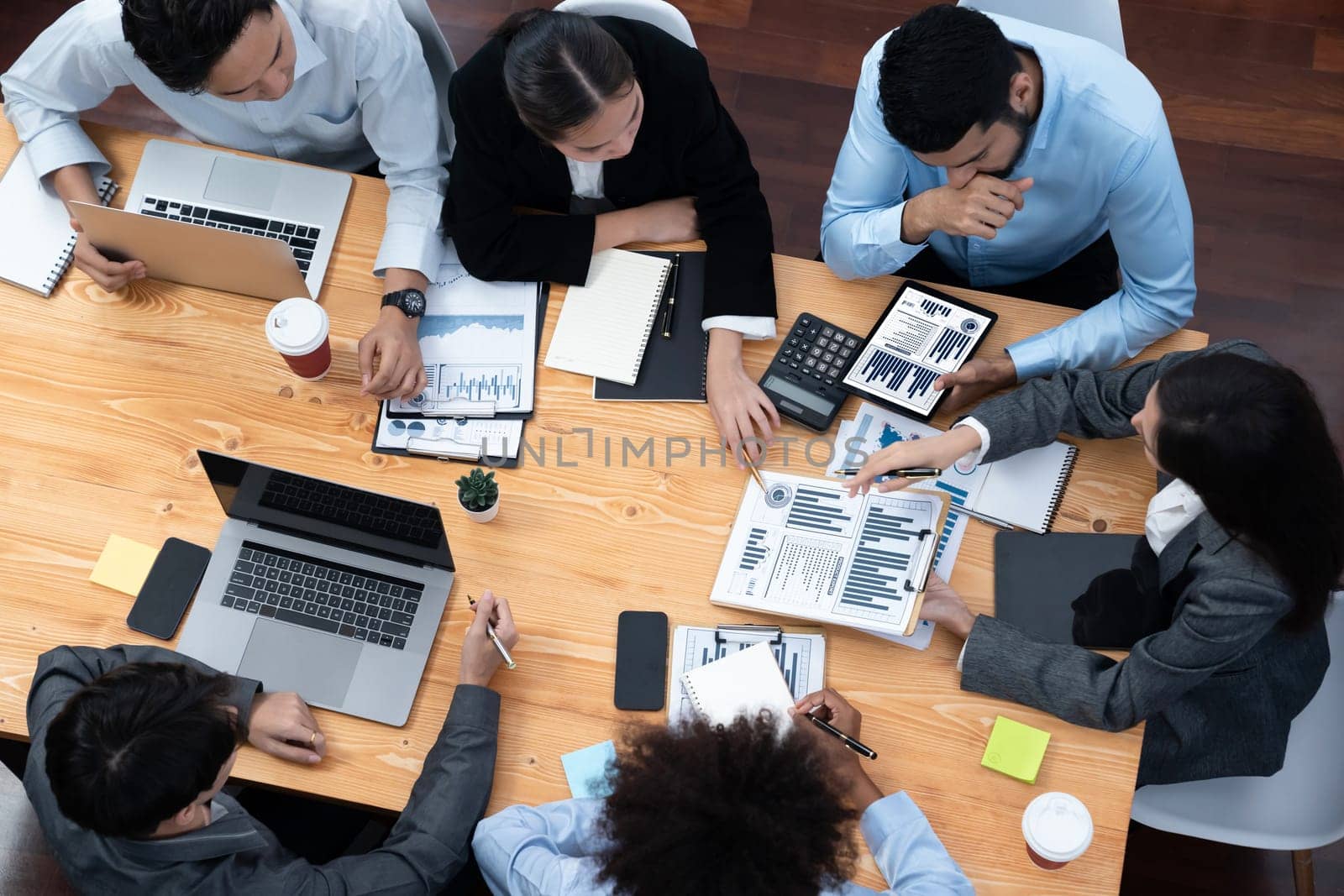 Top view multiracial analyst team use BI dashboard display on laptop screen, analyzing financial data for strategic decision. Fintech analyzes marketing indicators. Concord