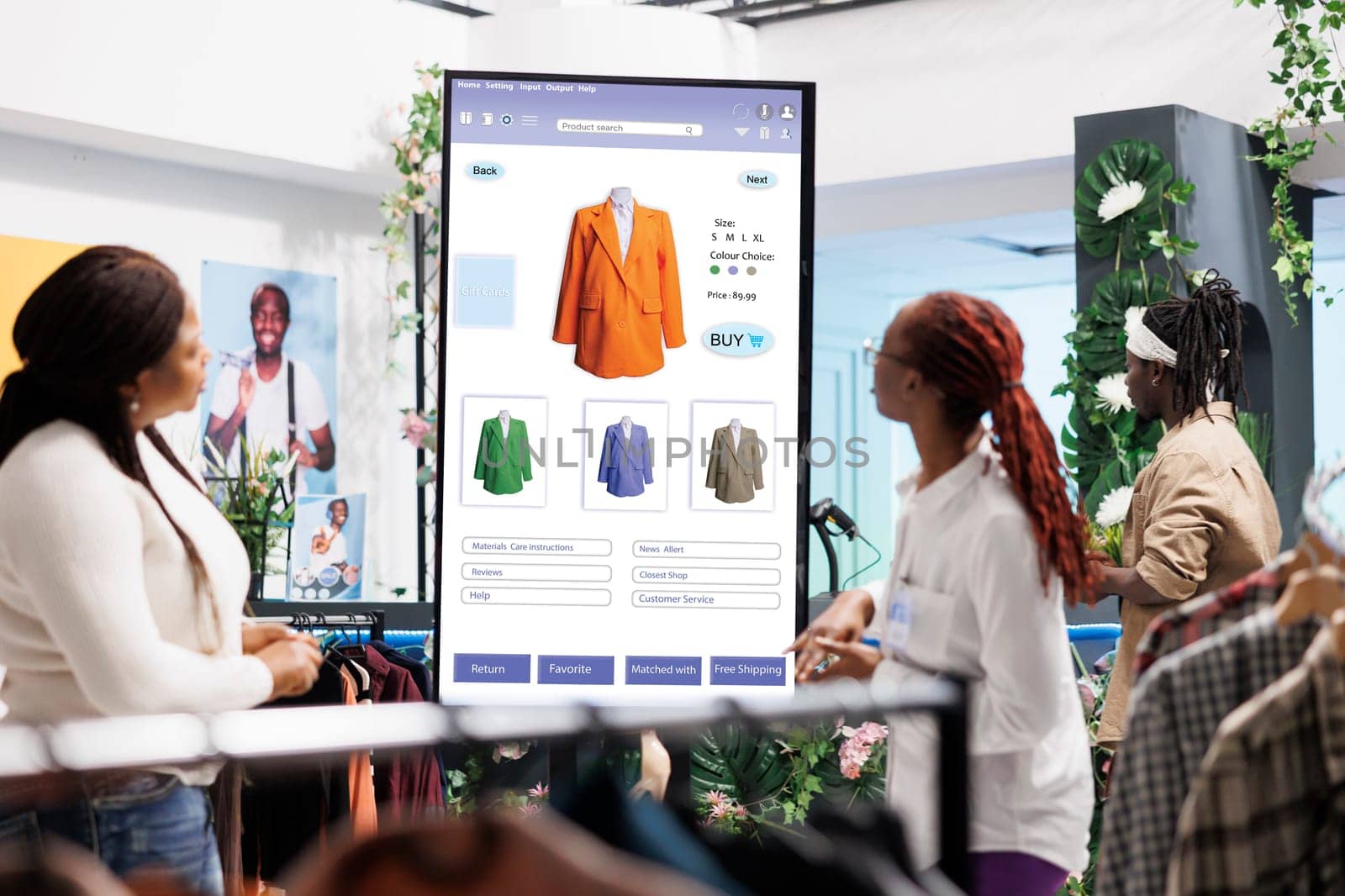 Store assistant helping client with kiosk service, female employee giving assistance in clothing store. Shopper looking for trendy items on interactive board monitor, self ordering.