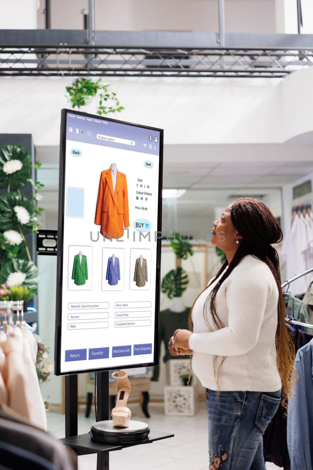 Shopper choosing clothes on display by DCStudio
