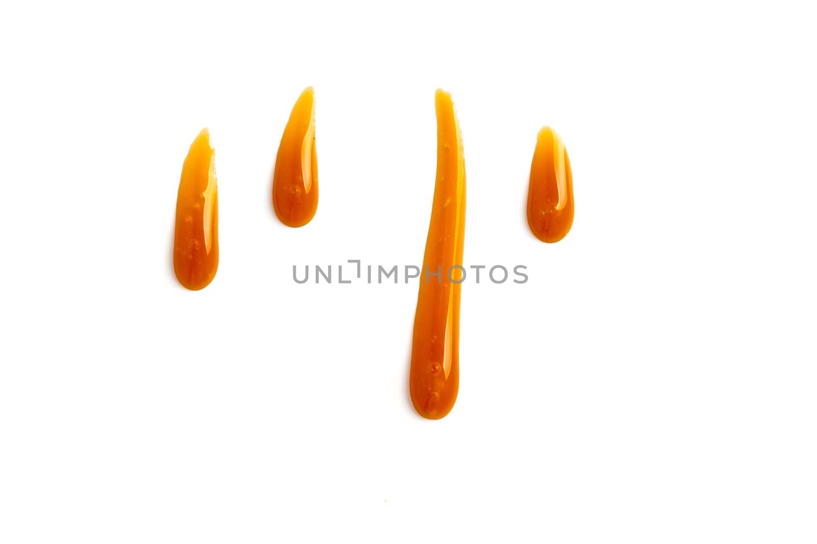 sweet caramel sauce drops isolated on white background Top view or flat lay. Caramel drops isolated on white with clipping path.