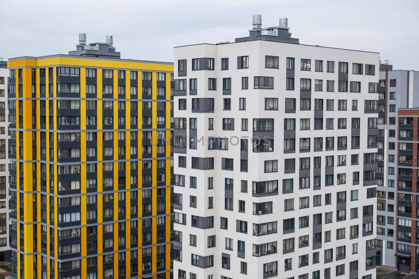 New apartment buildings with windows and balconies. Modern european complex by AnatoliiFoto