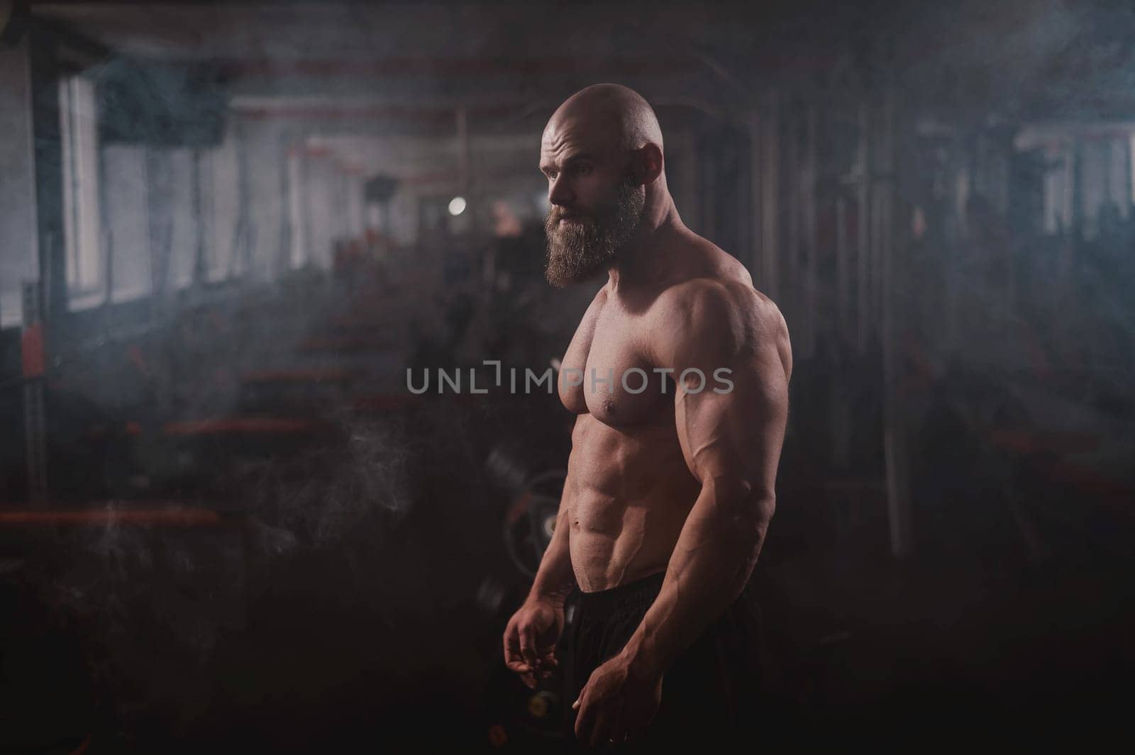 Caucasian bald man posing in the gym