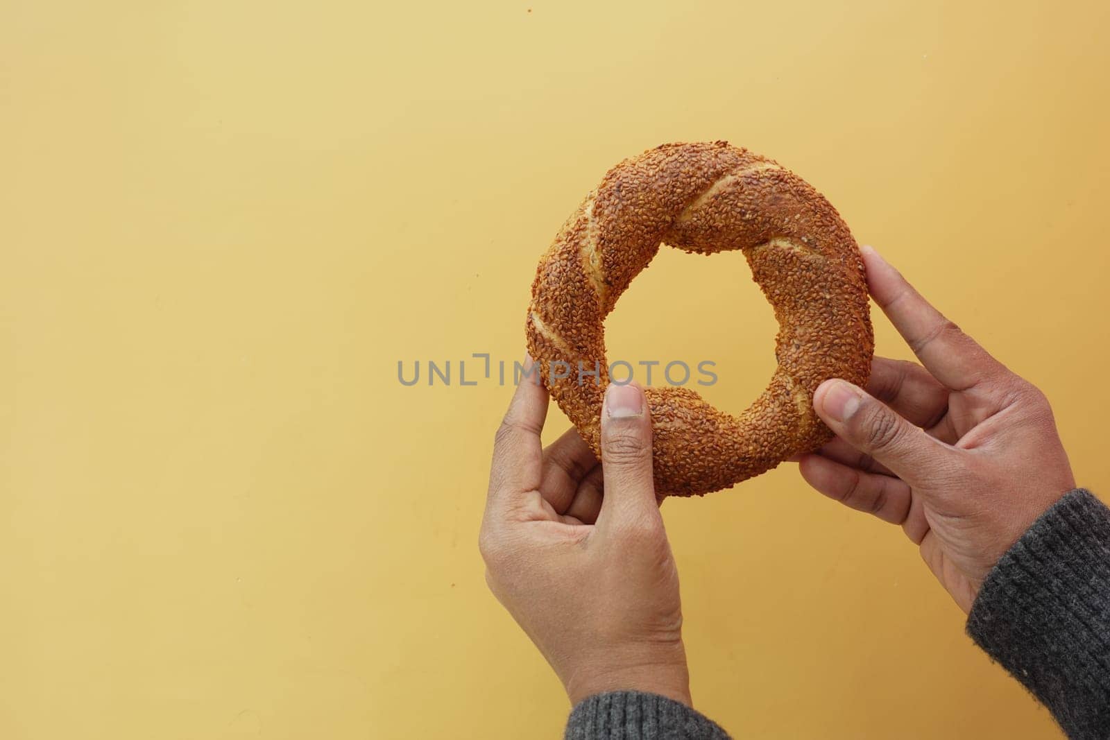 hand holding a turkish Bagel Simit by towfiq007