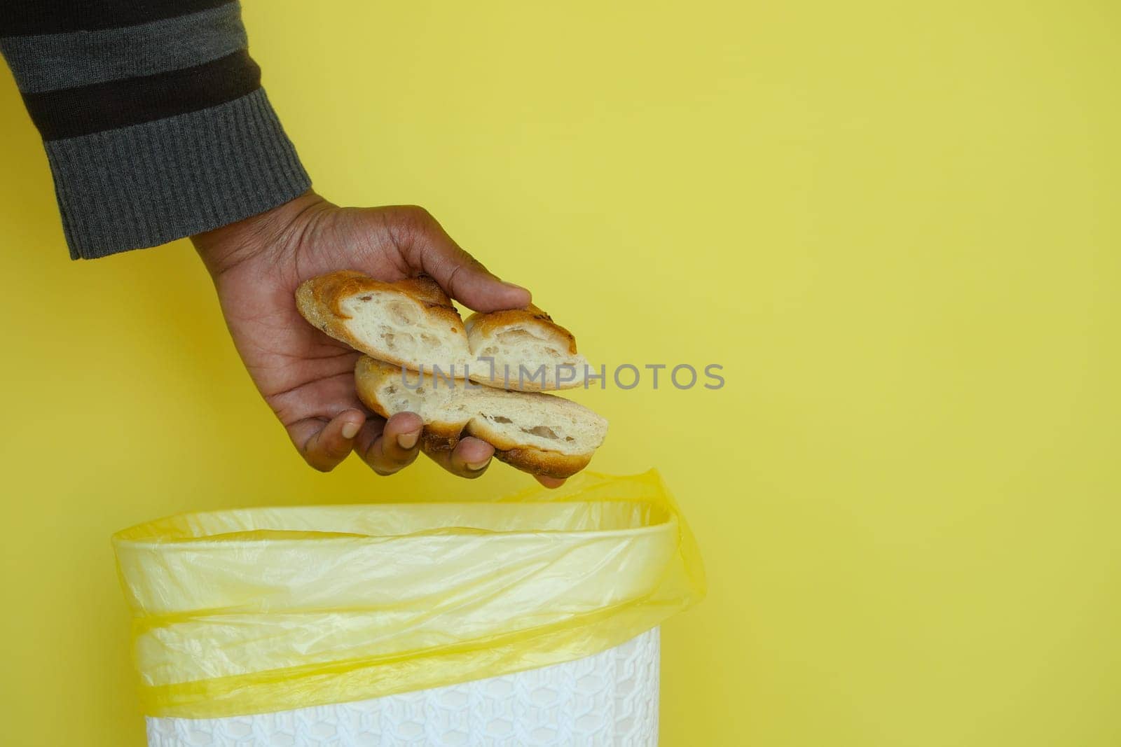 throwing old breads in a garbage bin by towfiq007