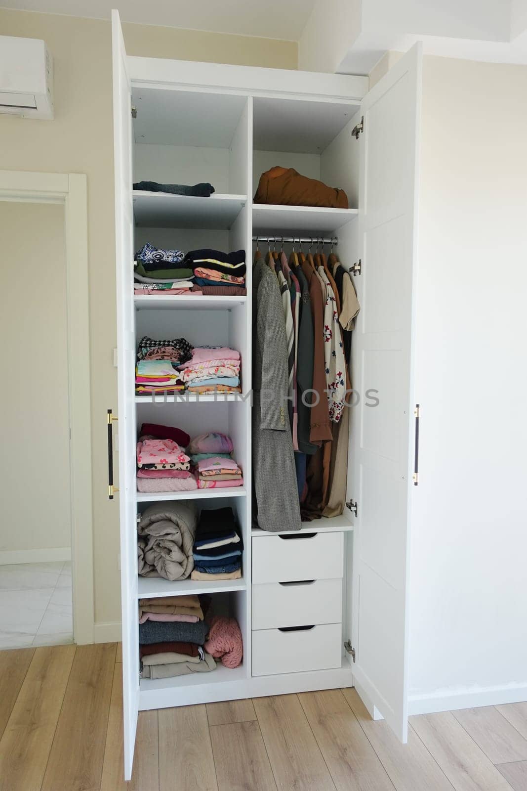 organizing clothes in a closet on shelves for comfort and ease of access