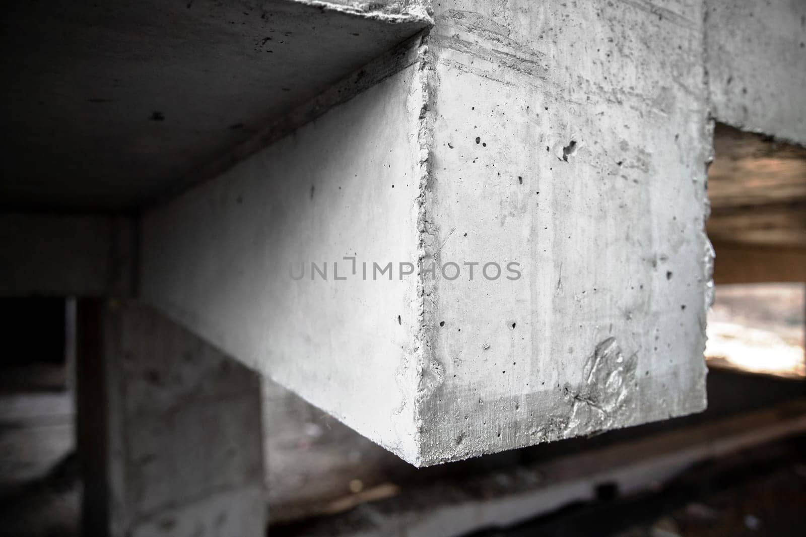 Reinforced concrete structure of columns, beams and floors of a building under construction. Close-up on a beam by Rom4ek