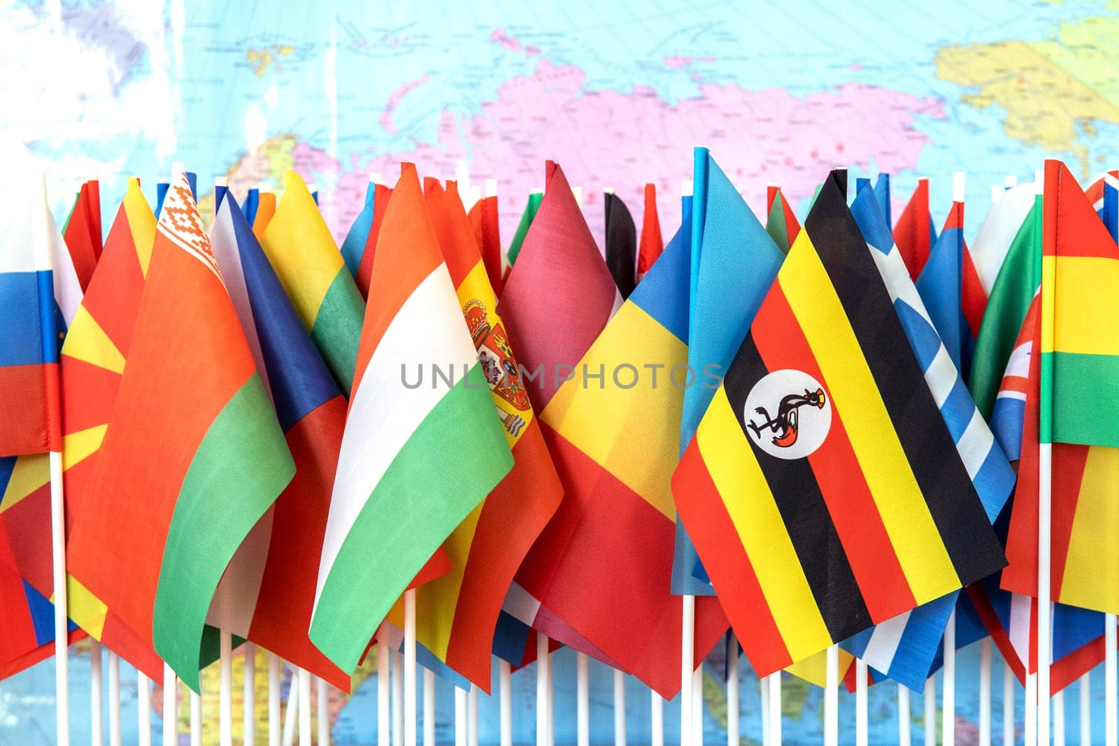 Embracing Diversity: A Tapestry of Nations - Flags of the World Against the Backdrop of World Map.
