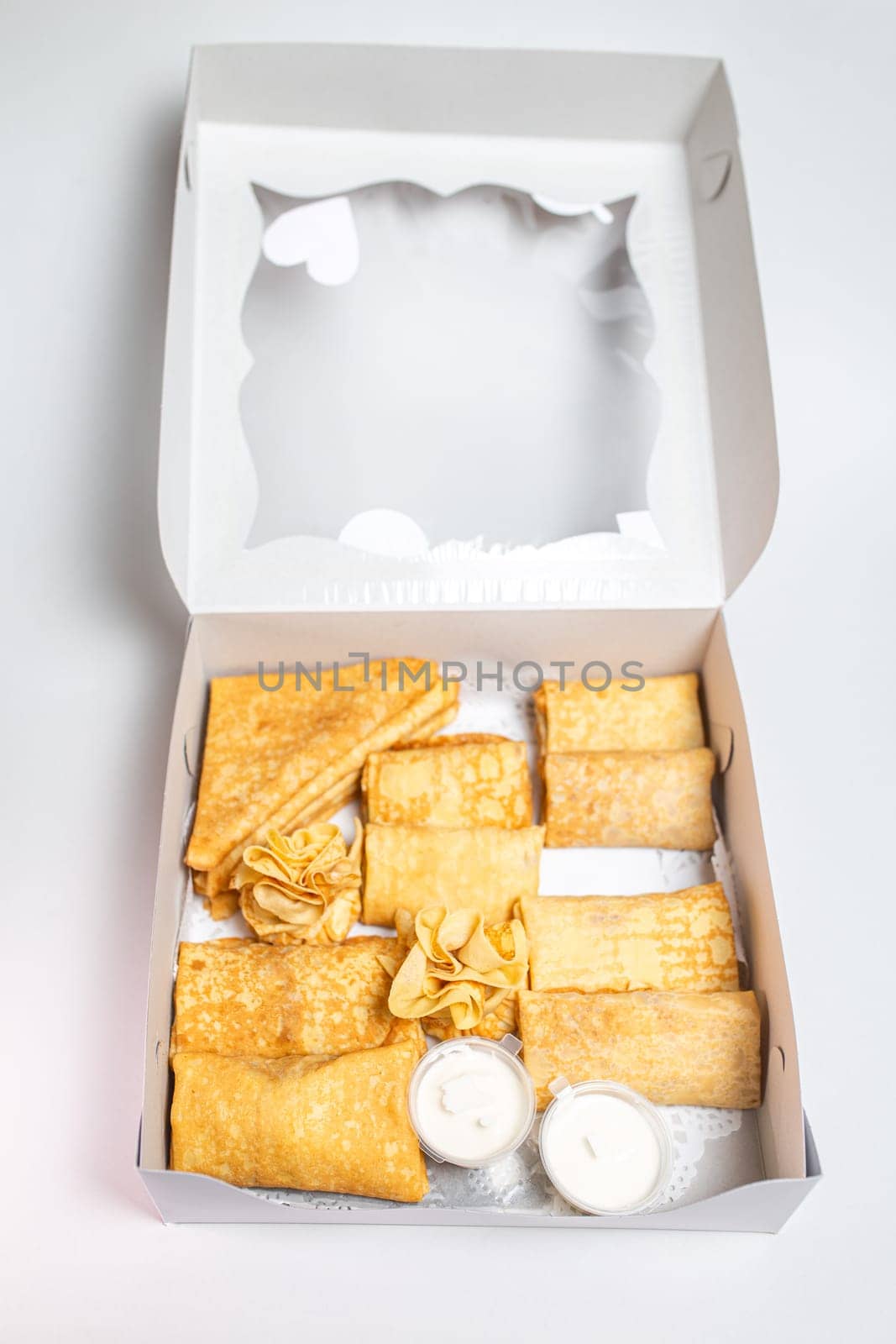 top view assorted pancakes with various fillings in a white package. Carnival menu. by Pukhovskiy