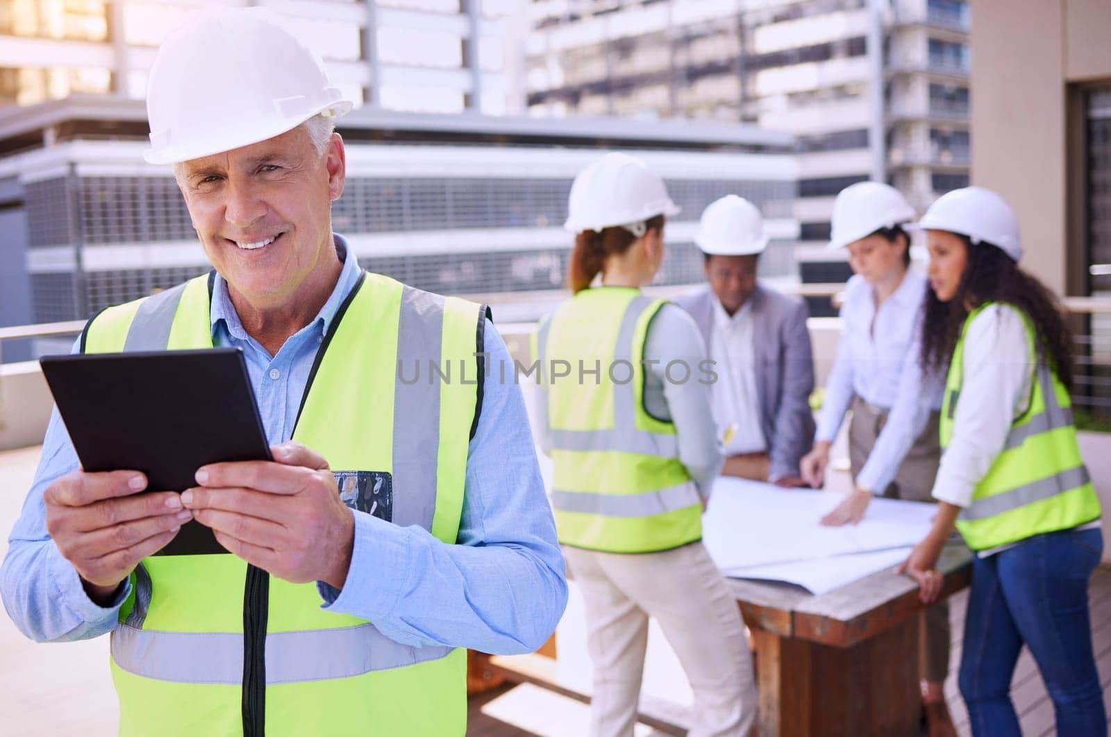 Mature, man and tablet with architect and team in meeting, construction inspection and digital checklist with portrait. Urban infrastructure, project management and safety engineer with blueprint.