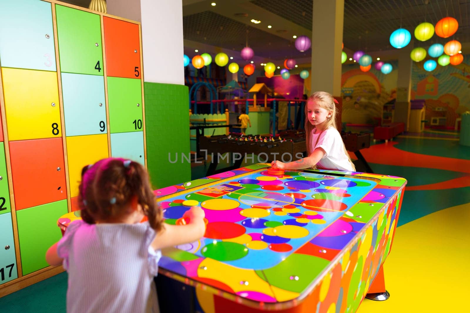 Young Girl Engaging in Colorful Board Game Fun at a Vibrant Playroom by Fabrikasimf