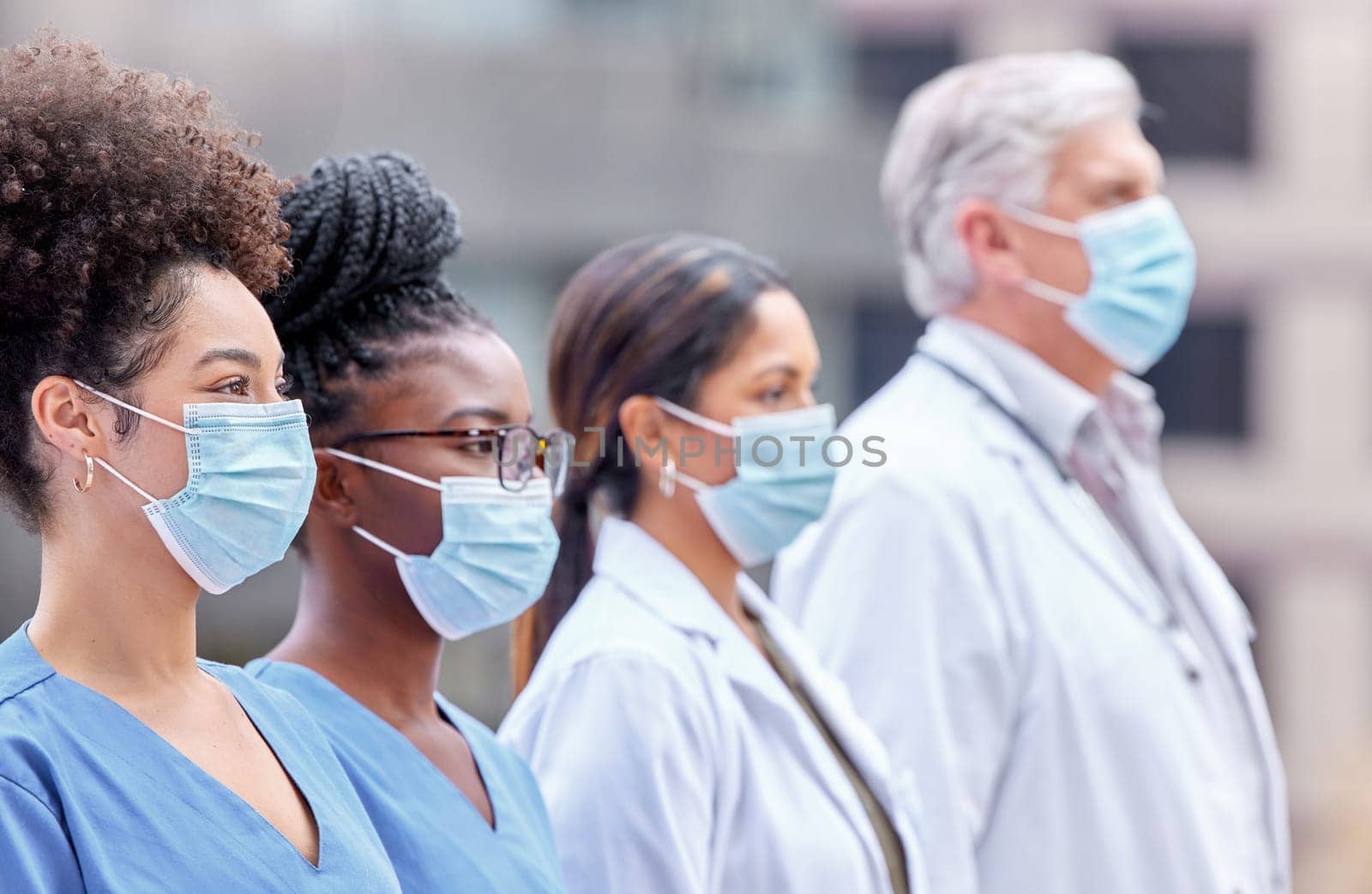 City, healthcare and doctors with mask for teamwork, collaboration and support for clinic staff. Hospital, nursing and men and women in row for medical care, service and wellness in pandemic safety.