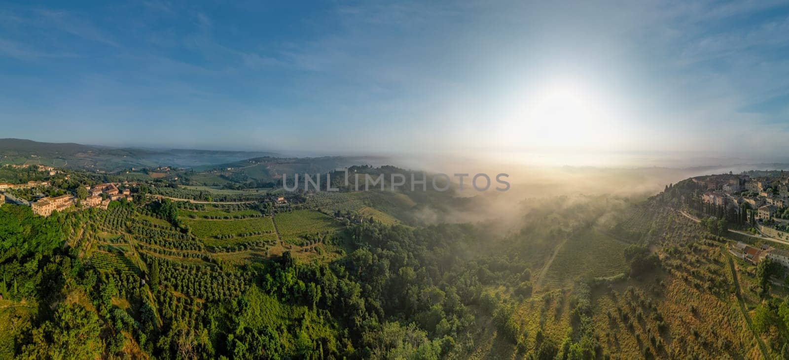 Tuscany landscape with cypress trees and blue sky with clouds