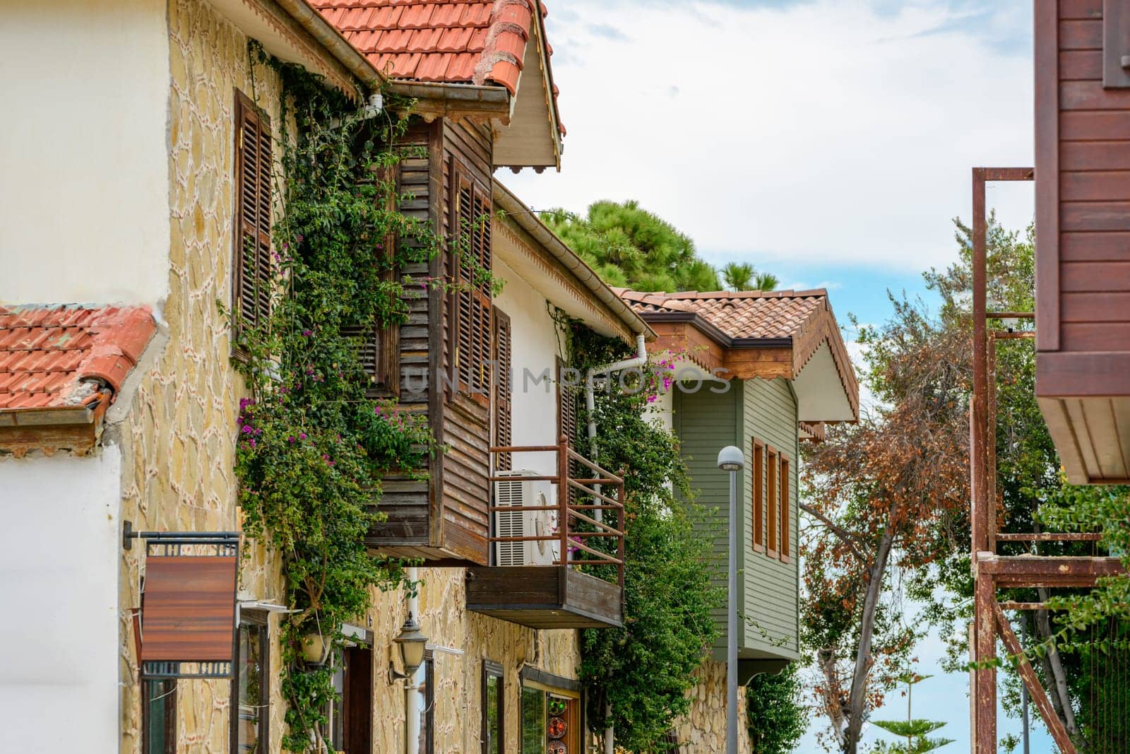 Restored houses with bay windows on the historical streets of Side Antalya by Sonat