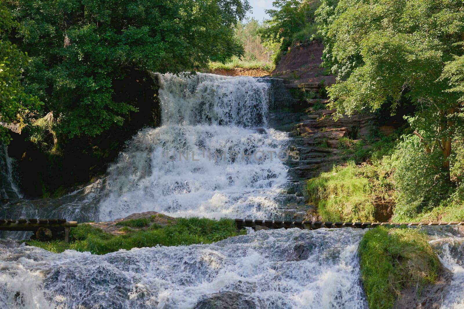 a large natural stream of water flowing in a channel to the sea, a lake, or another such stream