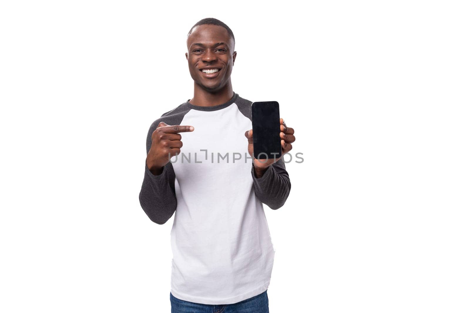 young smart charismatic american man has news and points finger at smartphone with mockup by TRMK