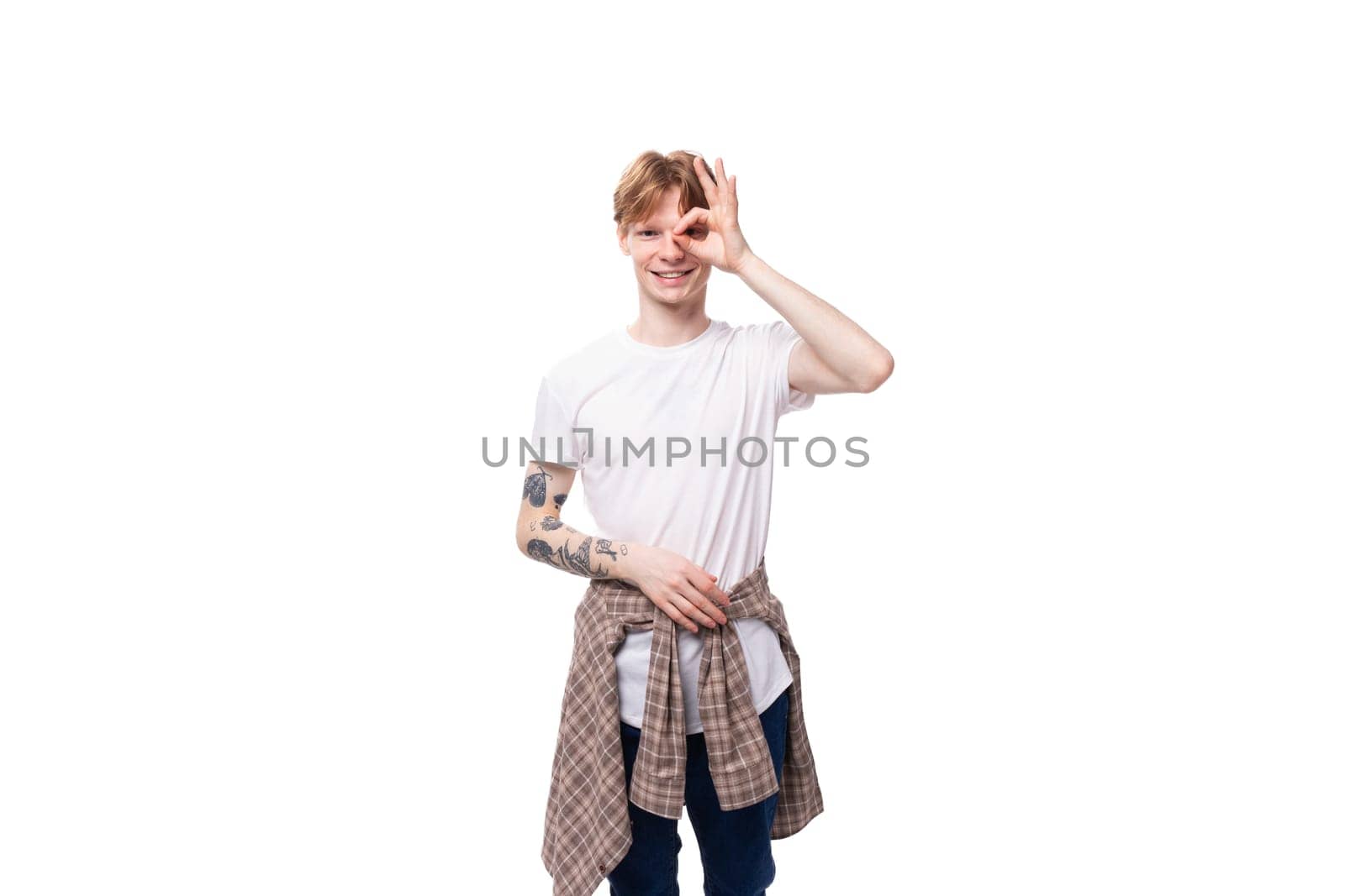 close-up of a slender young caucasian man with red hair in a white t-shirt on a white background by TRMK