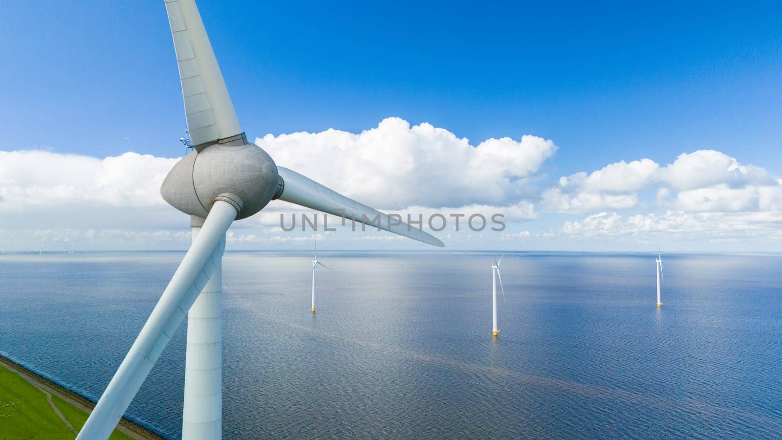 A mesmerizing view of wind turbines gracefully spinning in the ocean, harnessing the power of the wind to generate clean energy.