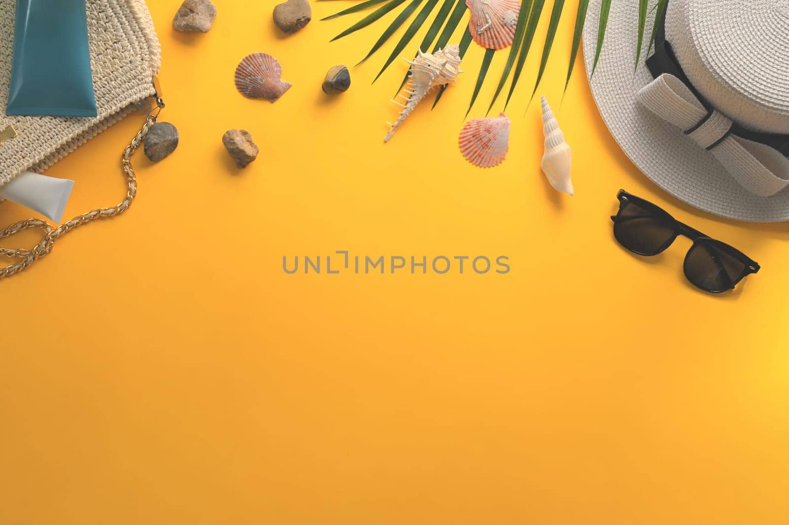 Traveler accessories and seashells on yellow background. Summer and travel vacation concept.