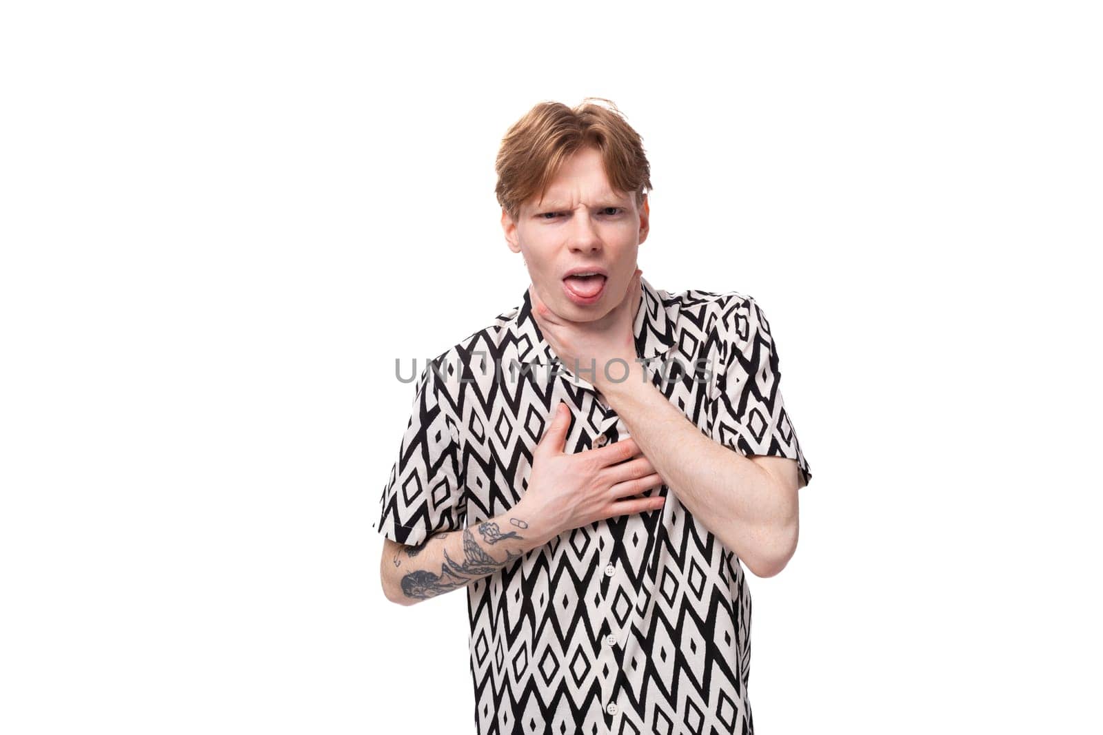 a young european guy with red hair in a shirt feels anxious.