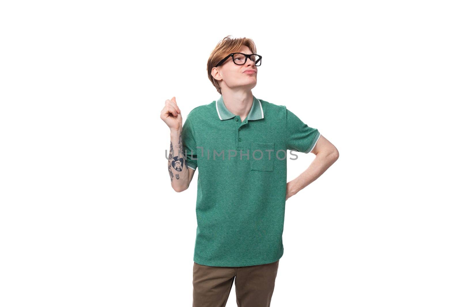 young dreaming european guy with red hair in glasses raised his head up and thinks by TRMK