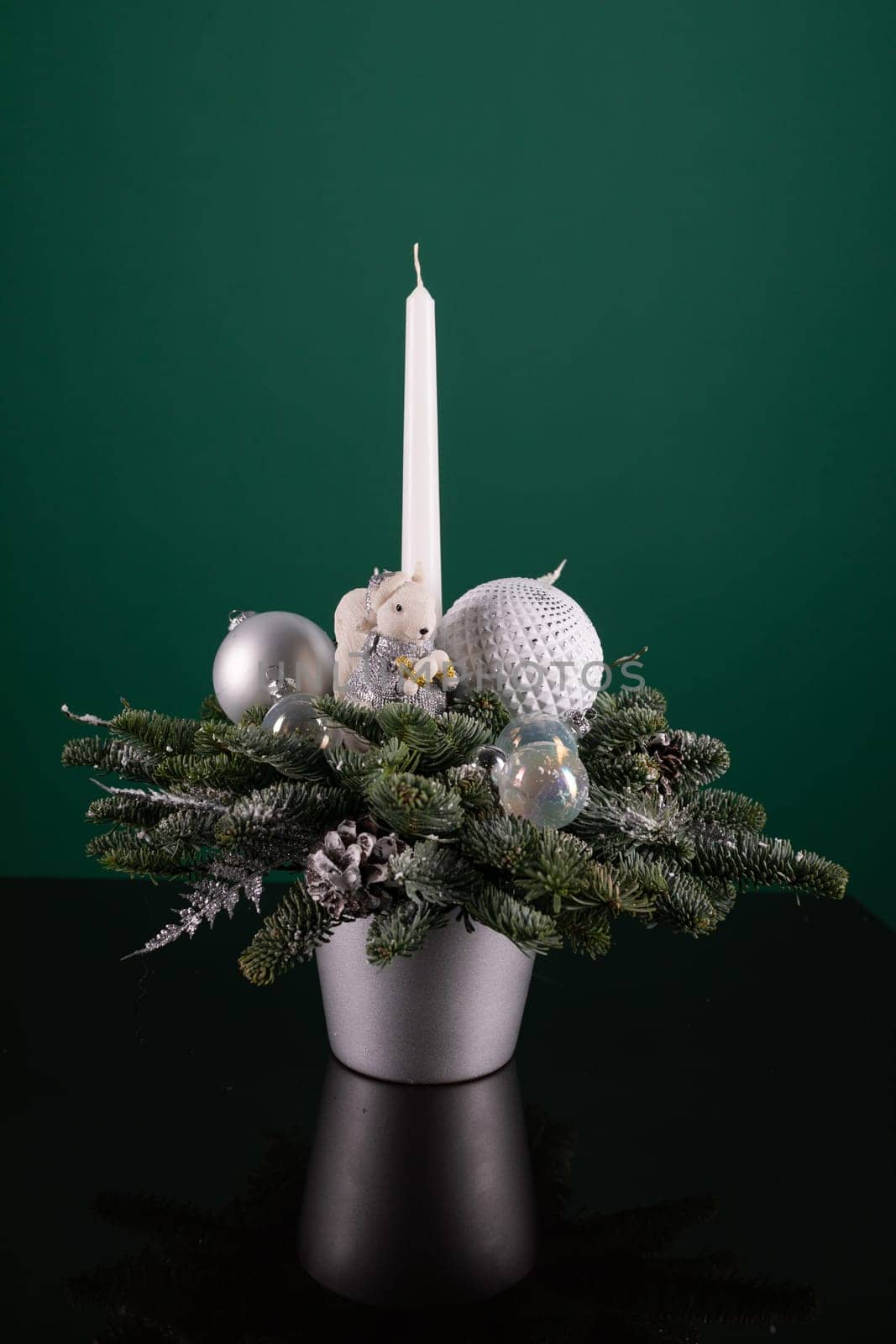 A white candle is placed neatly on top of a sturdy table surface. The candle appears unused, showing no signs of previous burning. Light reflects off the candles smooth surface, creating a simple yet elegant scene.
