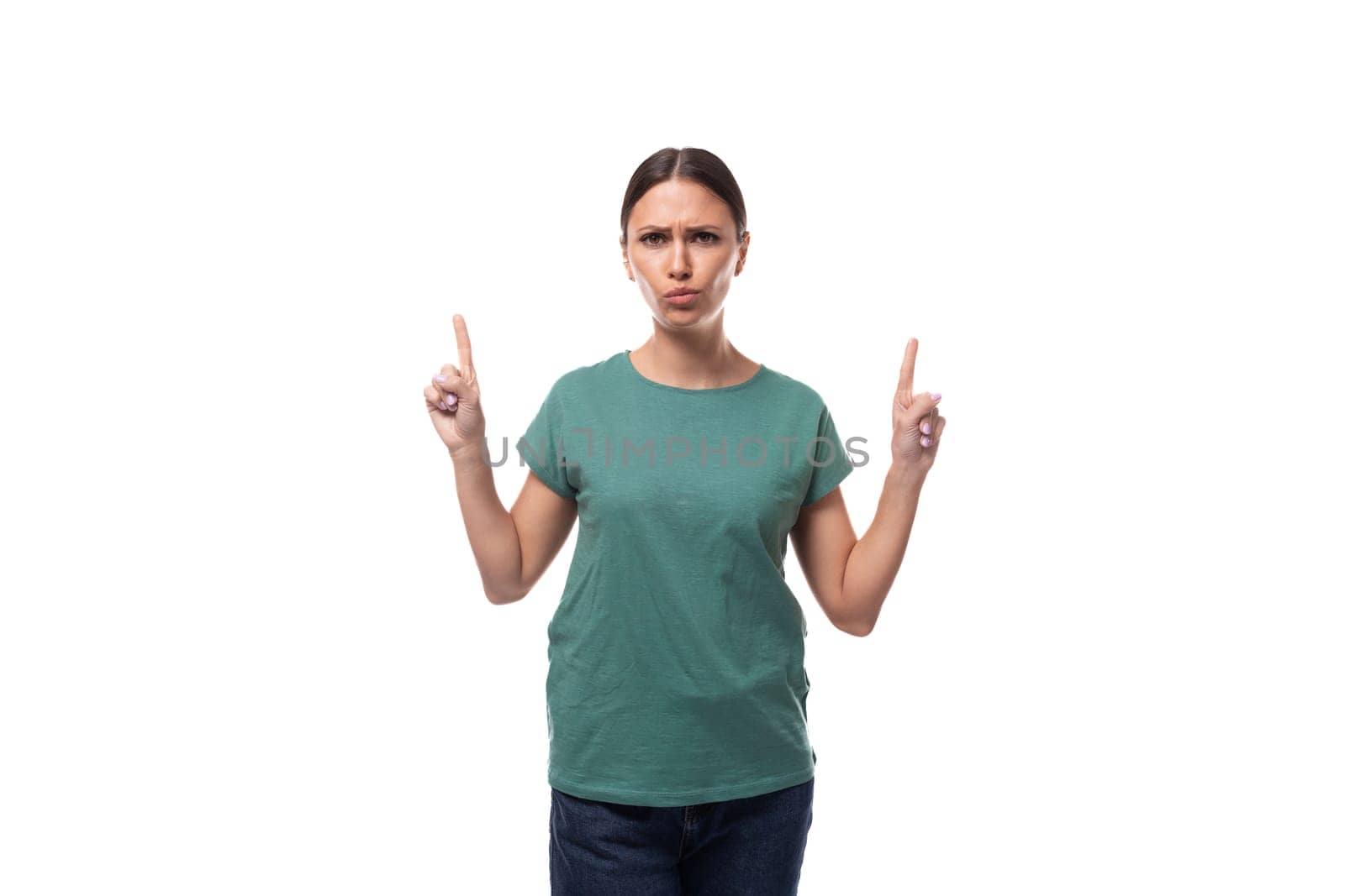 young black-haired woman in a green basic t-shirt with surprise tells the news by TRMK