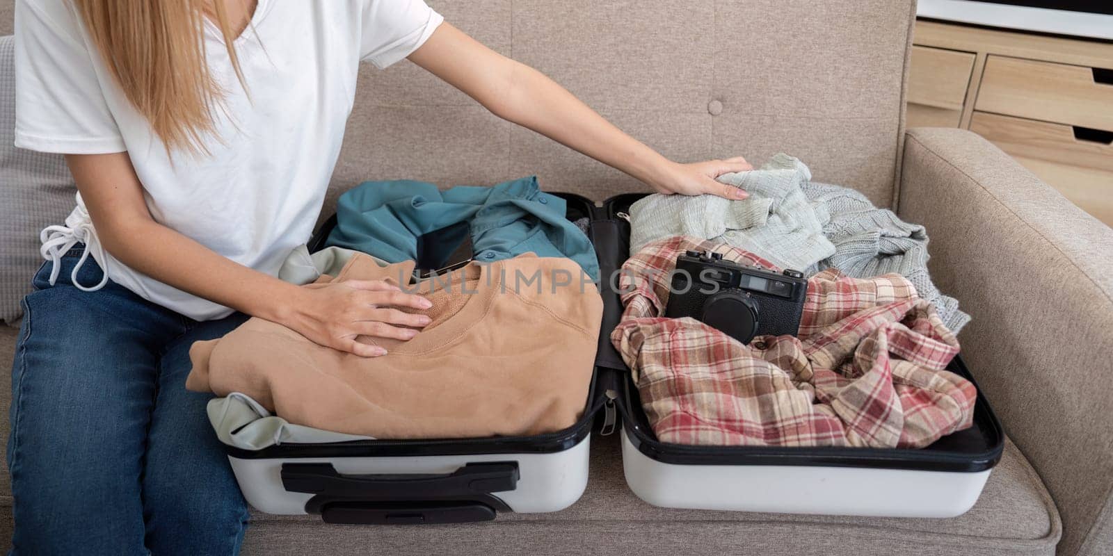 Woman and suitcase for travel summertime vacation packing clothing. relax and getaway preparation.