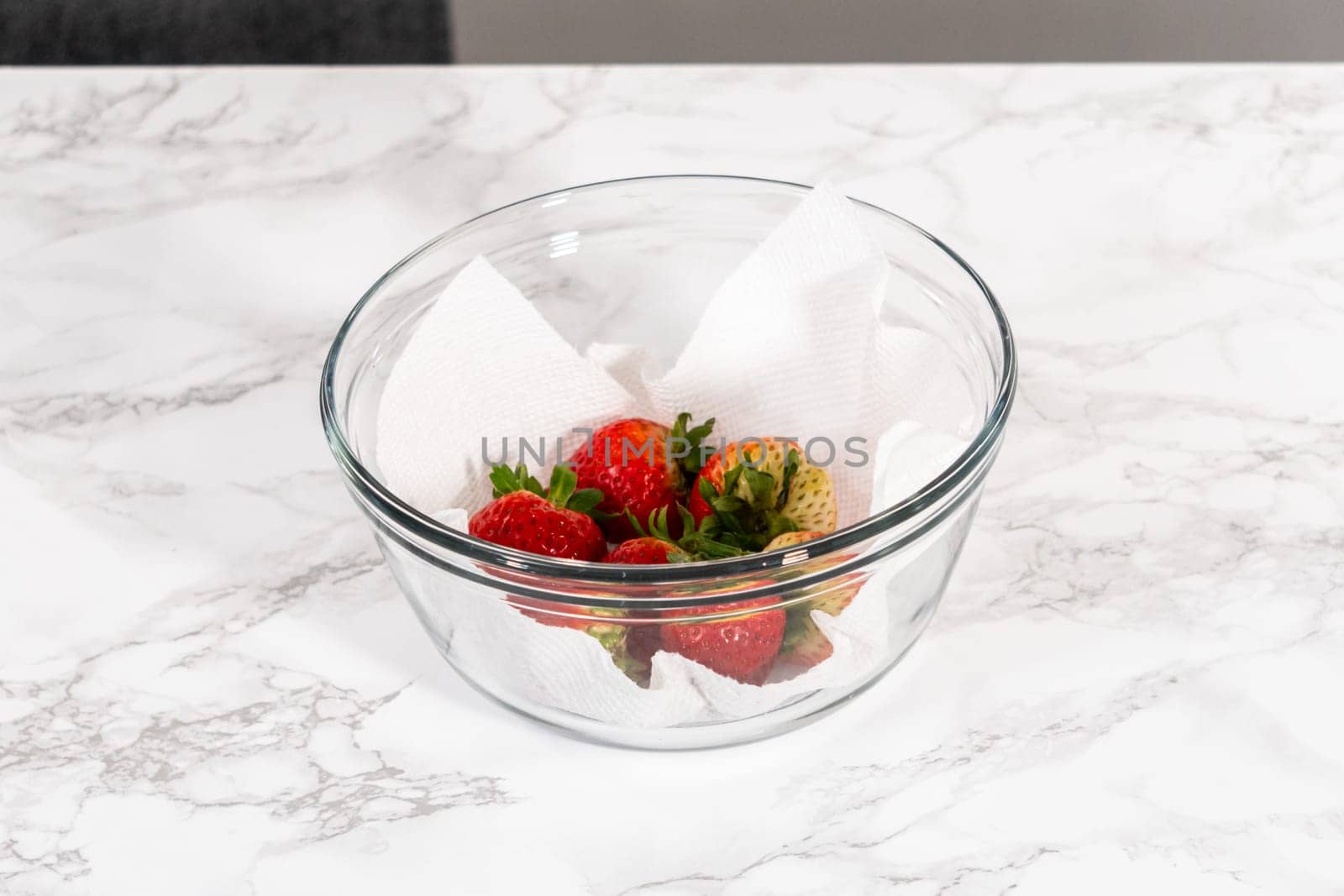 Washed and Dried Strawberries Neatly Stored in a Glass Bowl by arinahabich