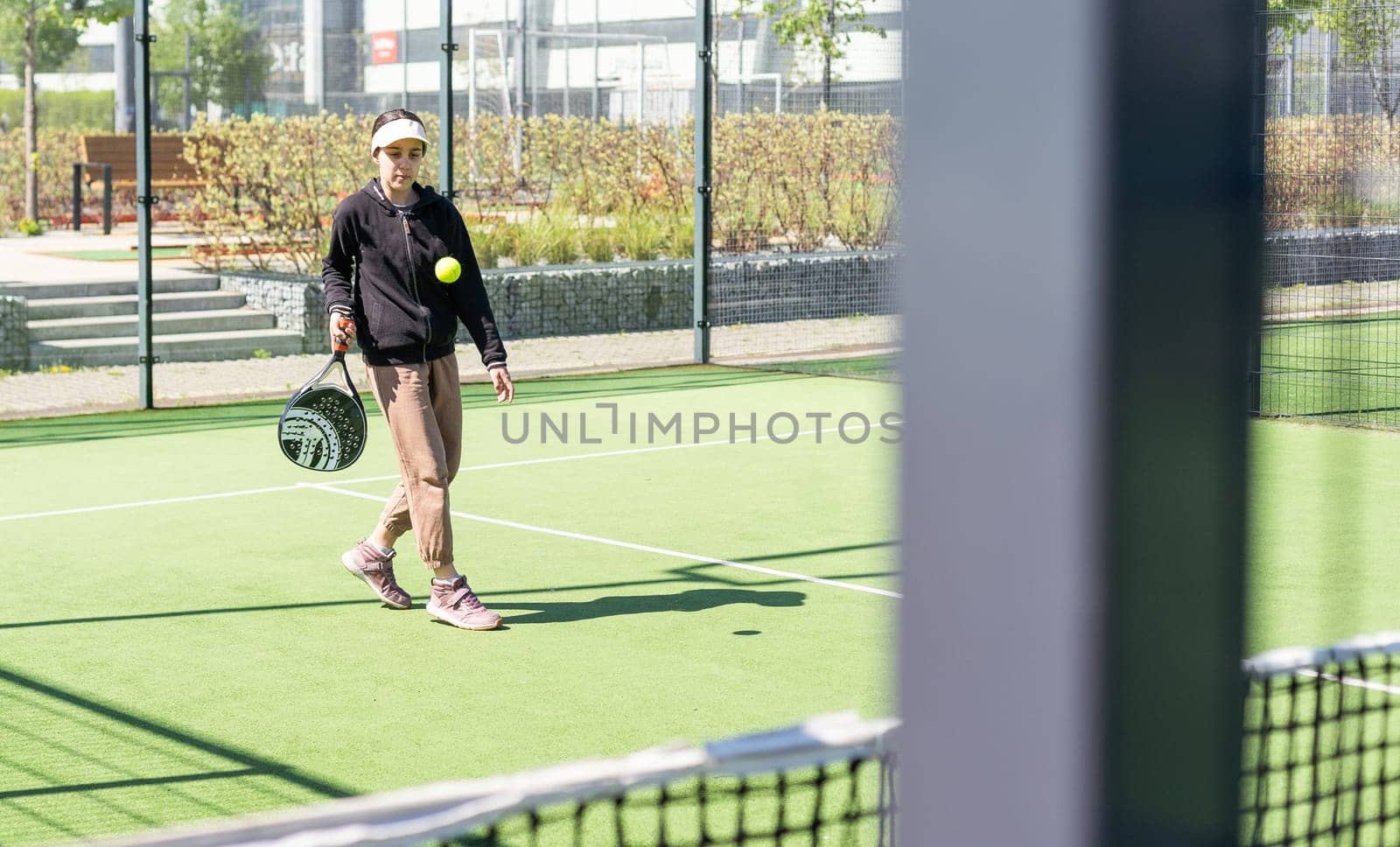 Young girls playing padel on a sunny day. High quality photo