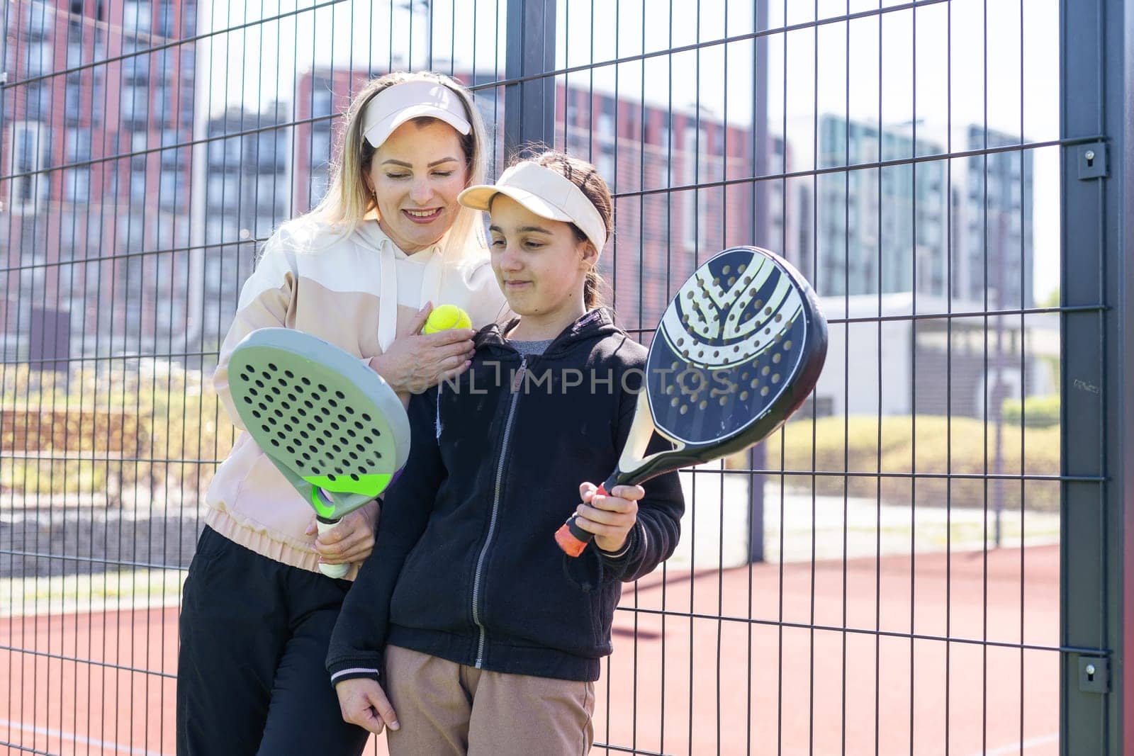 mother and daughter play padel by Andelov13