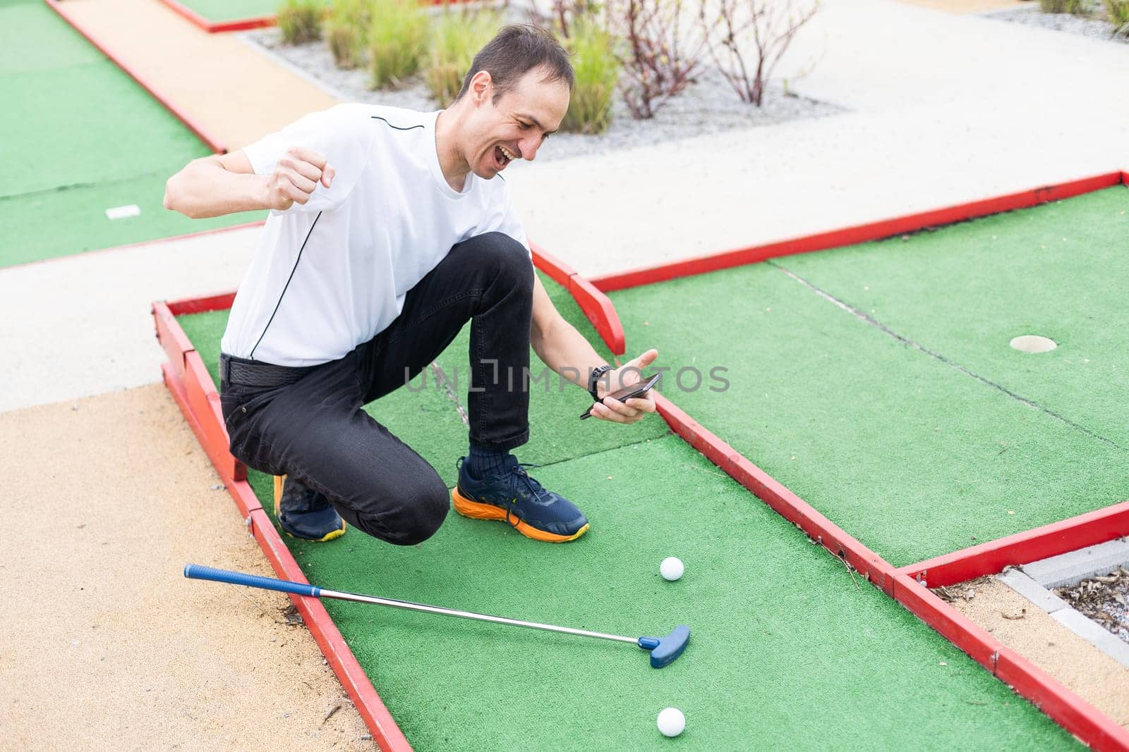 player looks at his hit on a mini golf course. High quality photo