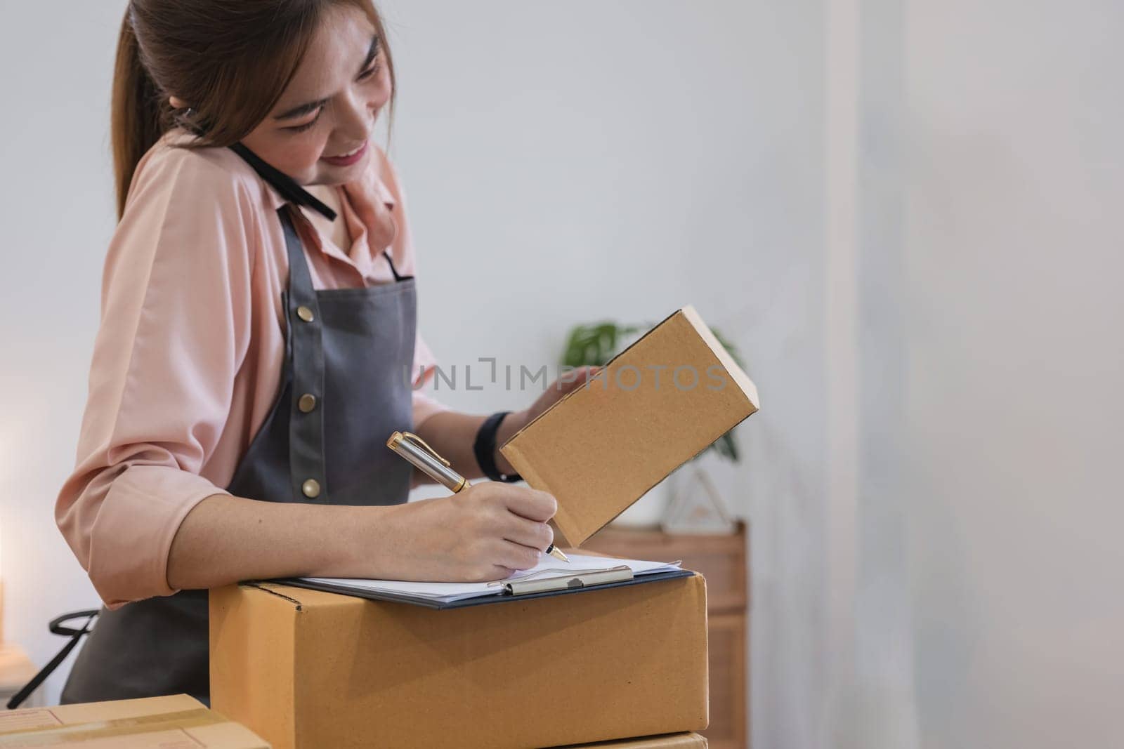 Startup small business entrepreneur SME, asian woman receive order on phone. Success young Asian small business owner home office, online sell marketing delivery.