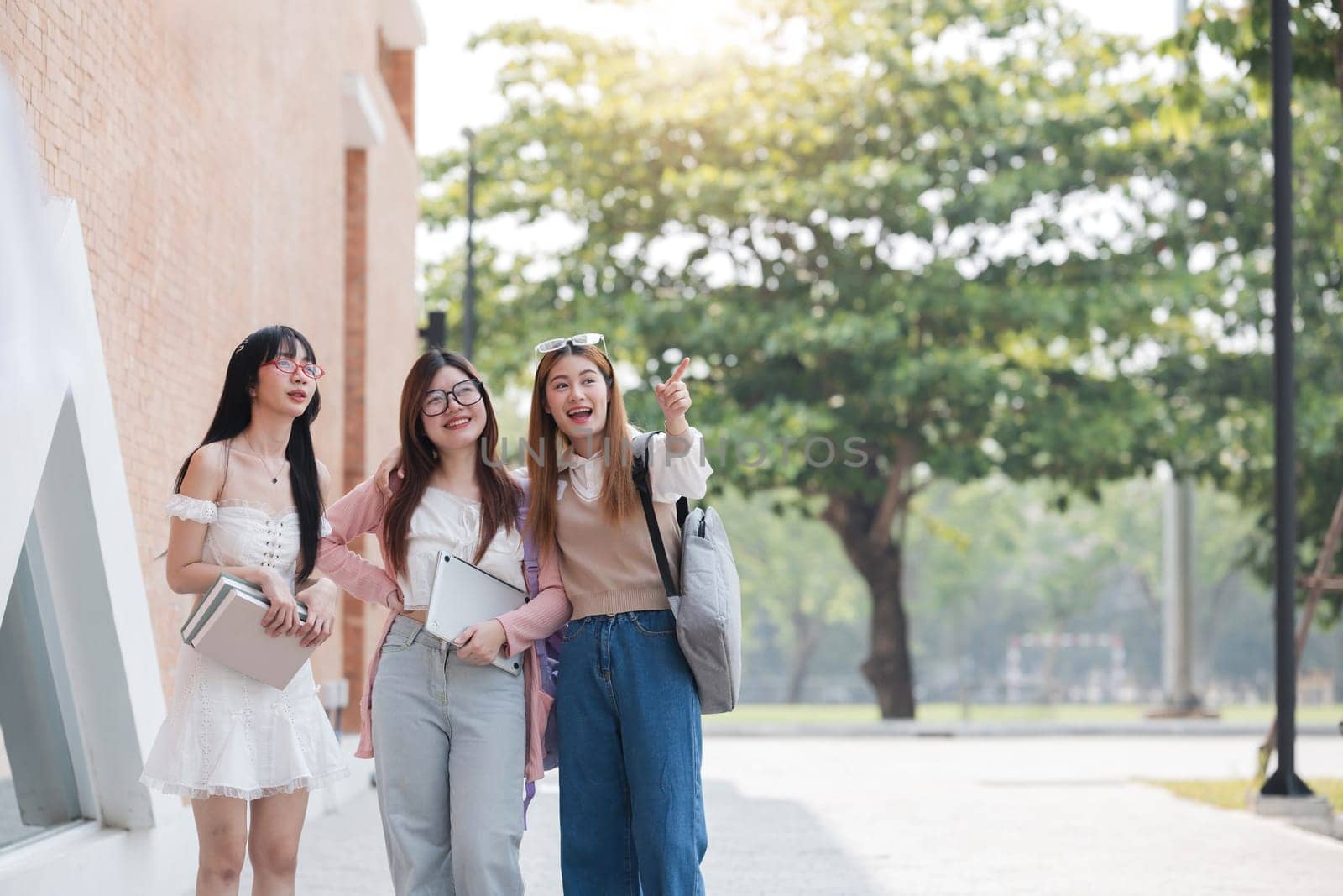 Group of Young Asian student walking and talking at university before class room. education, back to school concept.