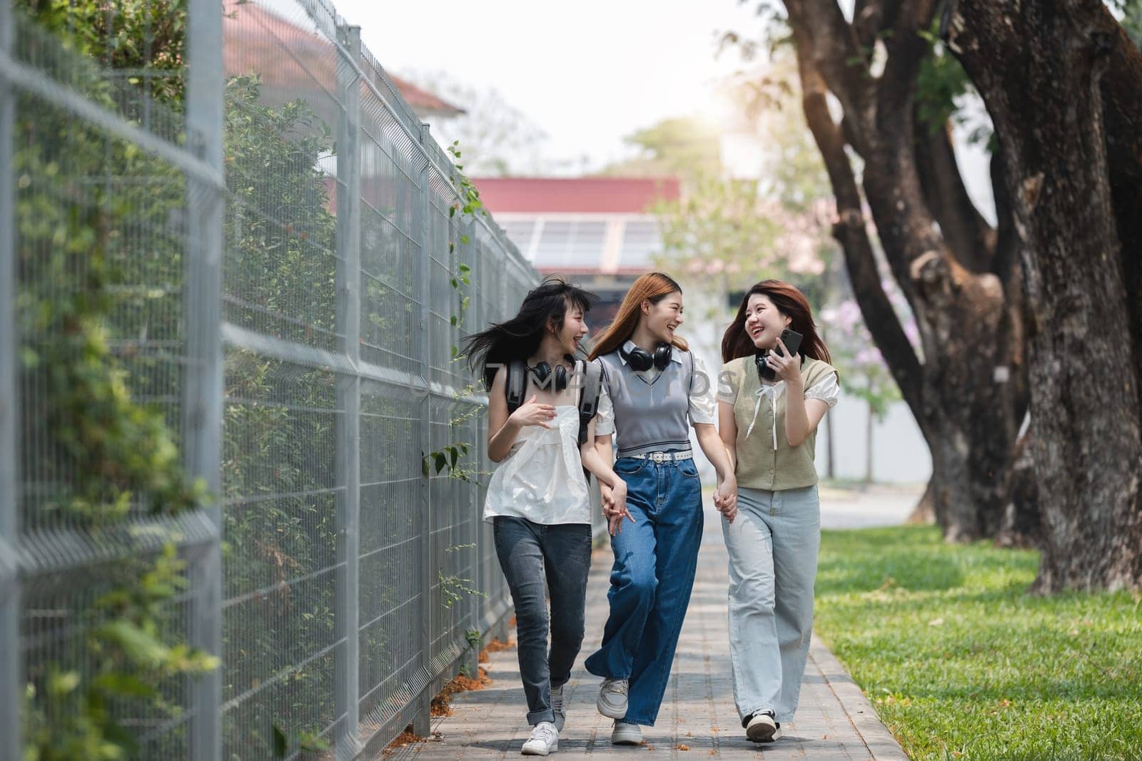 Group of Young Asian student walking and talking at university before class room. education, back to school concept by wichayada