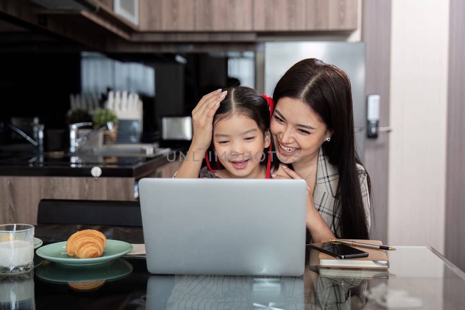 Working mom work from home office. businesswoman and cute child using laptop work freelancer workplace in home, Lifestyle family moment.