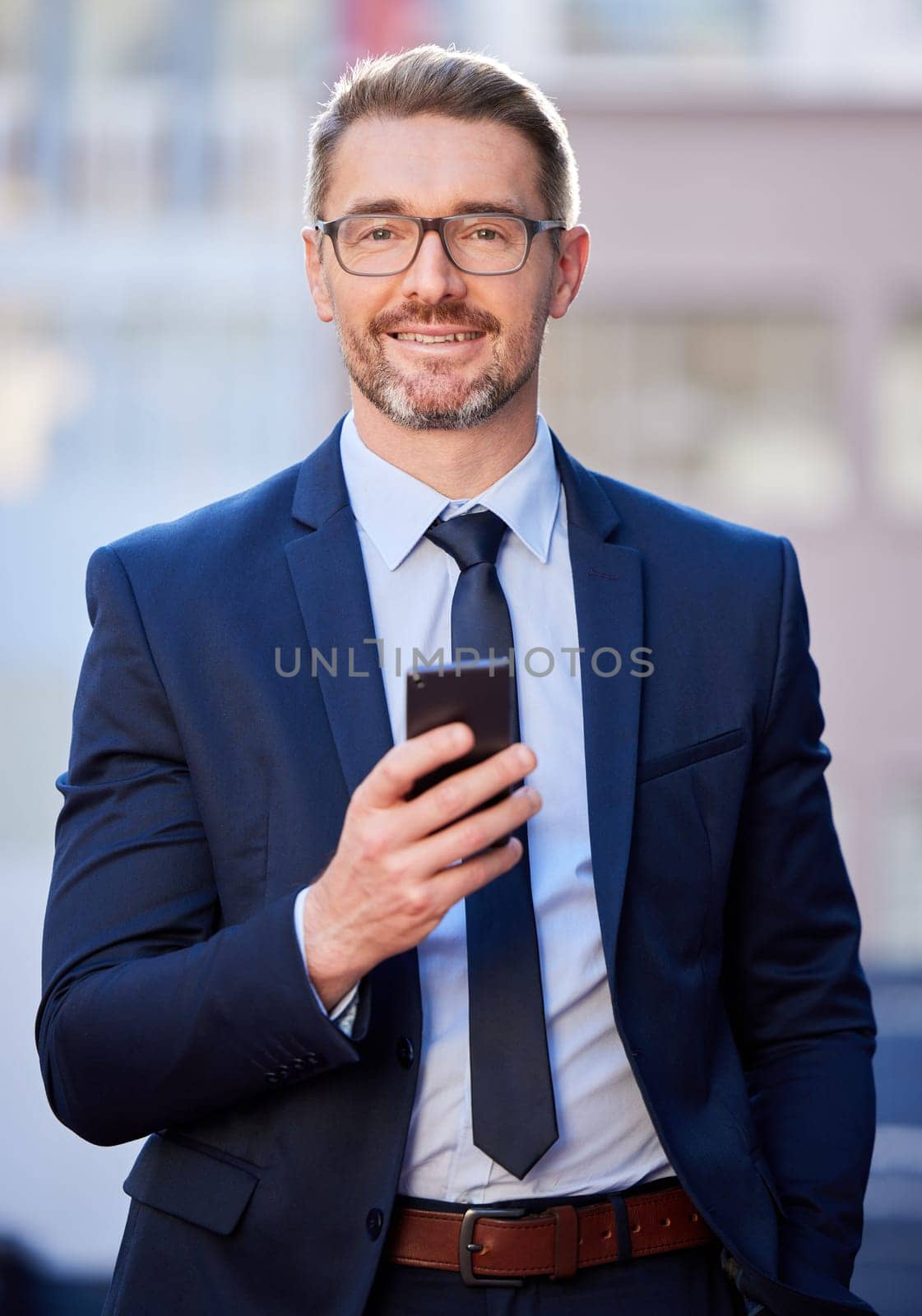 Portrait, businessman and cellphone with smile in city as project manager for company in Berlin. Male person, professional and technology for connection, communication and app in Germany for job by YuriArcurs