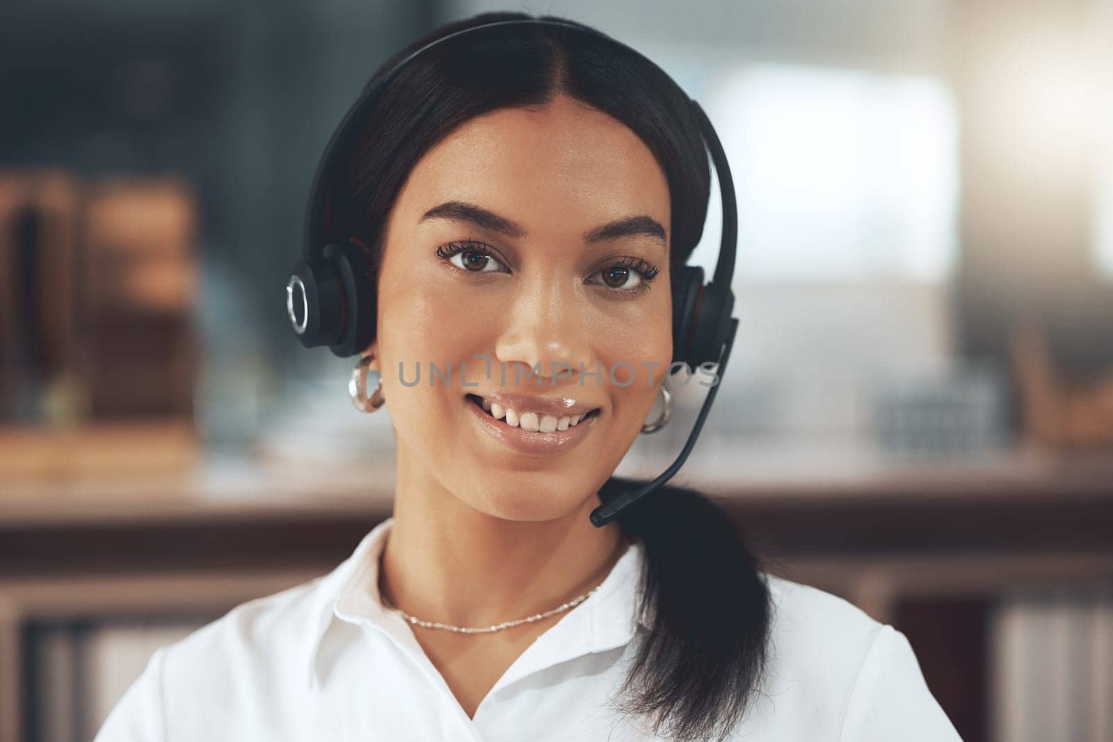 Call center, portrait and smile with woman consultant in telemarketing office for help or sales. Contact us, face and headset with happy agent in workplace for consulting, customer service or support.