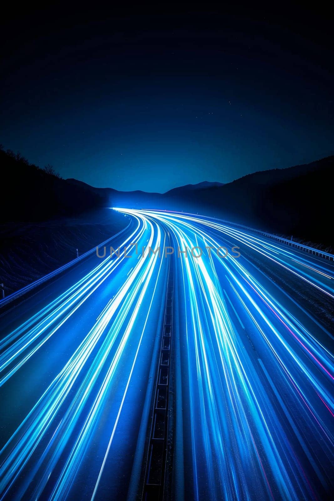 A long blue highway with a bright blue sky in the background. The sky is filled with stars and the highway is filled with streaks of light. Concept of motion and energy