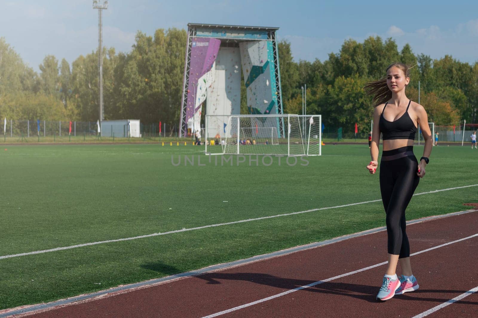 Young woman athlete is exercising at the stadium outdoors