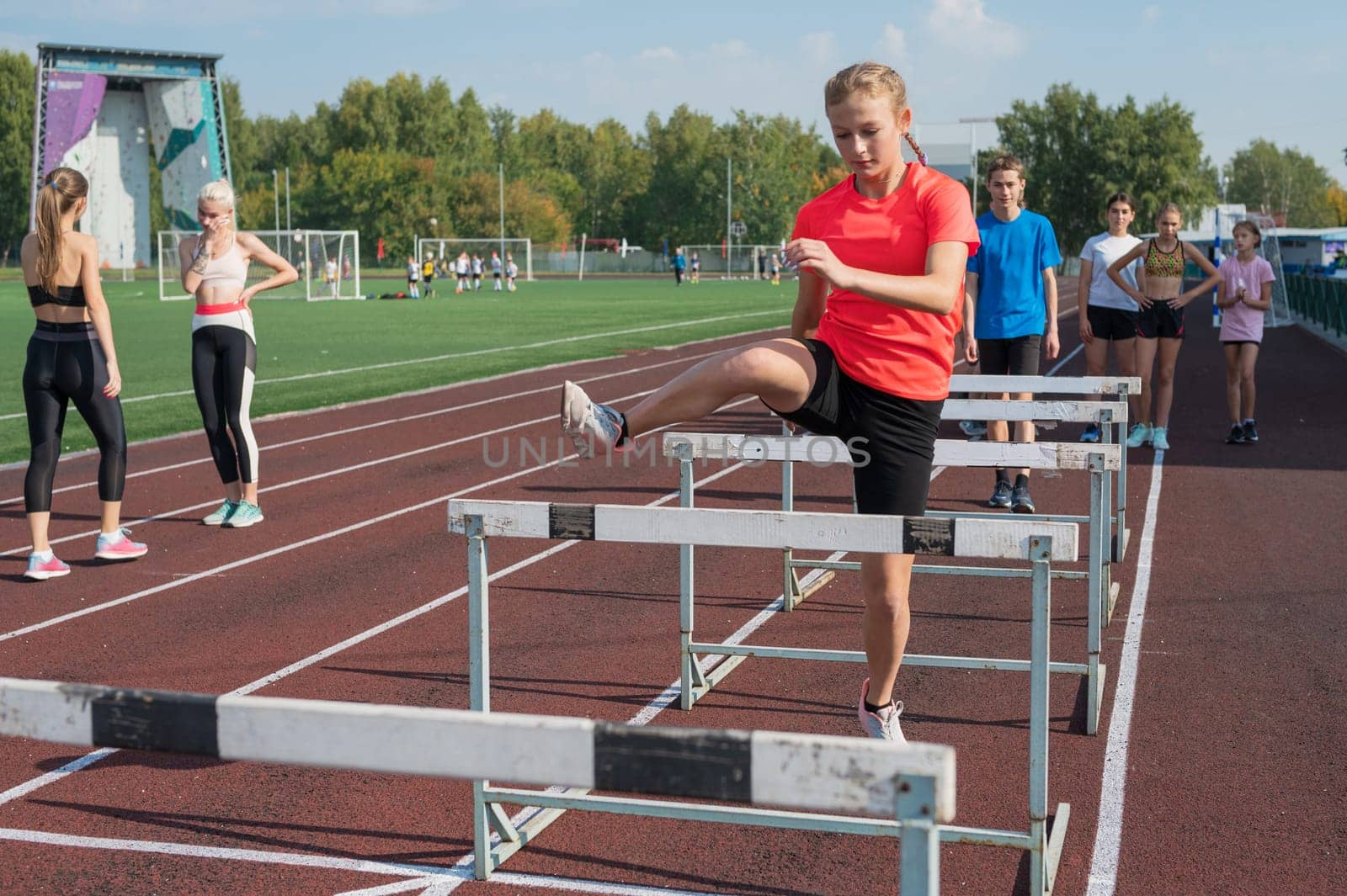 Group of young athletes training at the stadium. School gym trainings or athletics