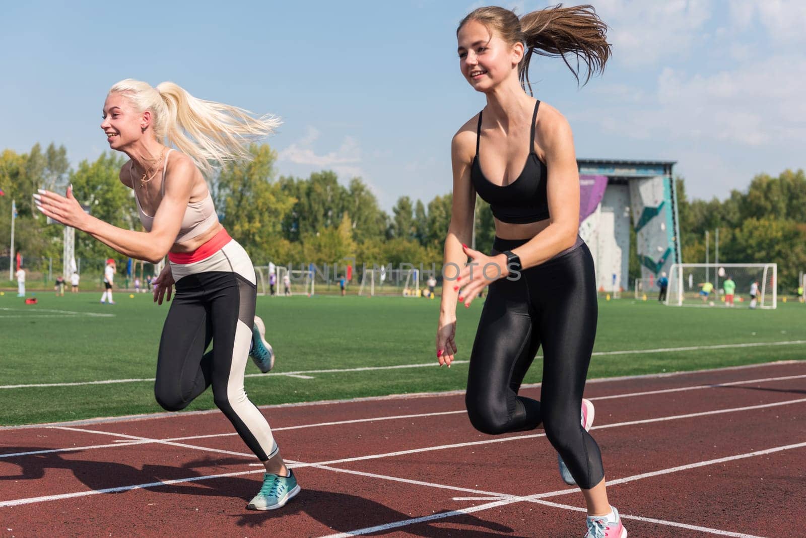 Two athlete young woman runnner at the stadium by rusak