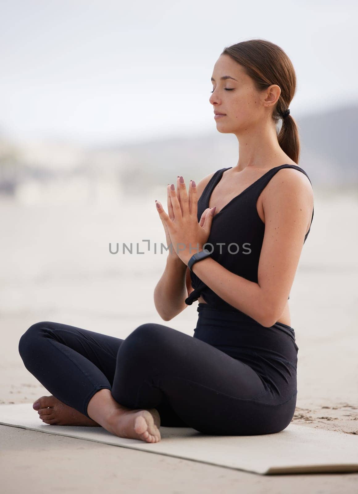 Nature, meditation and yoga with woman on beach for balance, peace or wellness in morning. Exercise, fitness and zen with serious person on sand by ocean or sea for holistic training or workout.