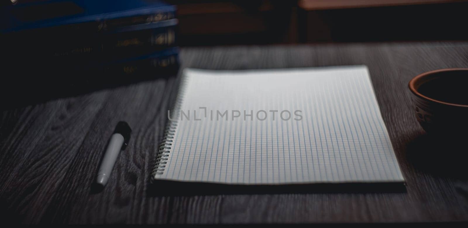 Workplace. Notebook with black marker and coffee mug on wooden table by NeuroSky