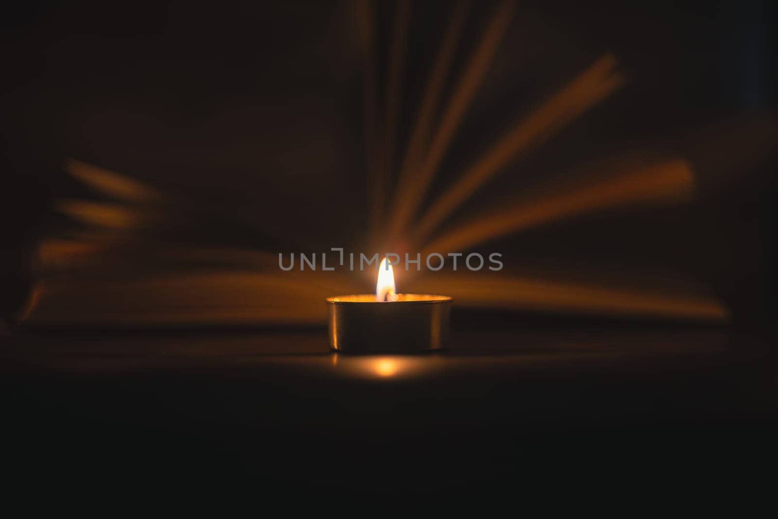 The Book in the candlelight. High quality photo