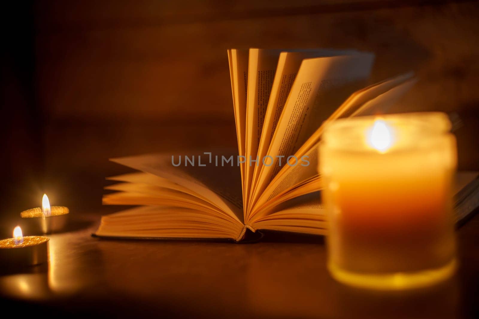 The Book in the candlelight. High quality photo