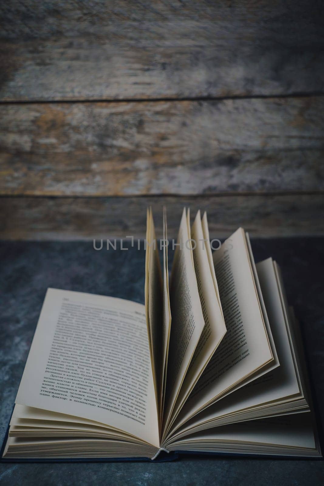 Open book on a gray wood background. High quality photo